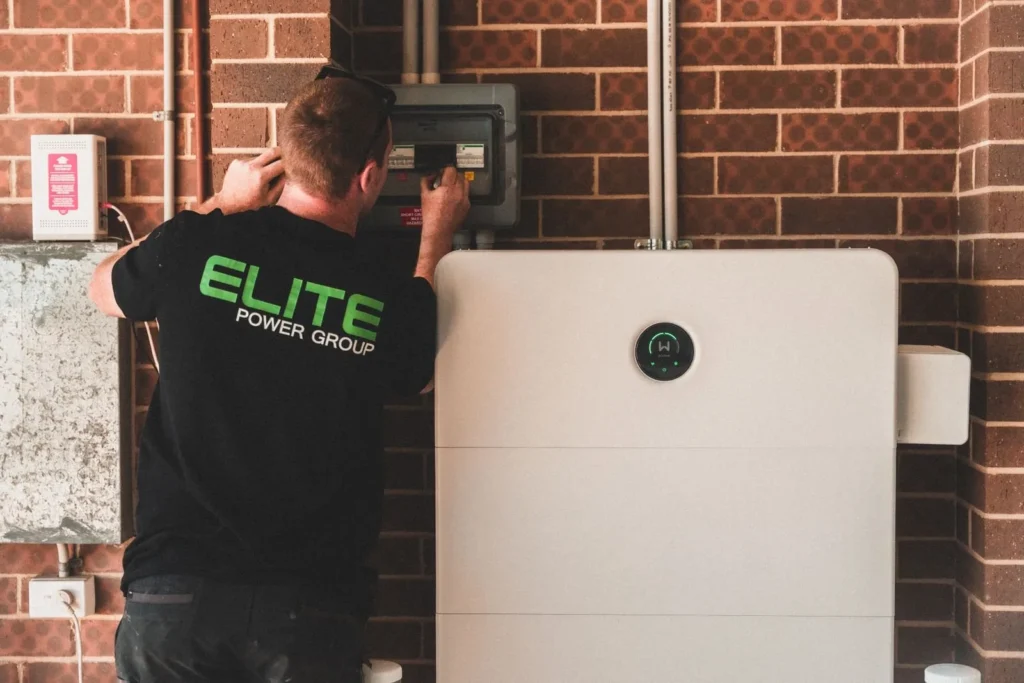 Electrician installing a home battery storage unit