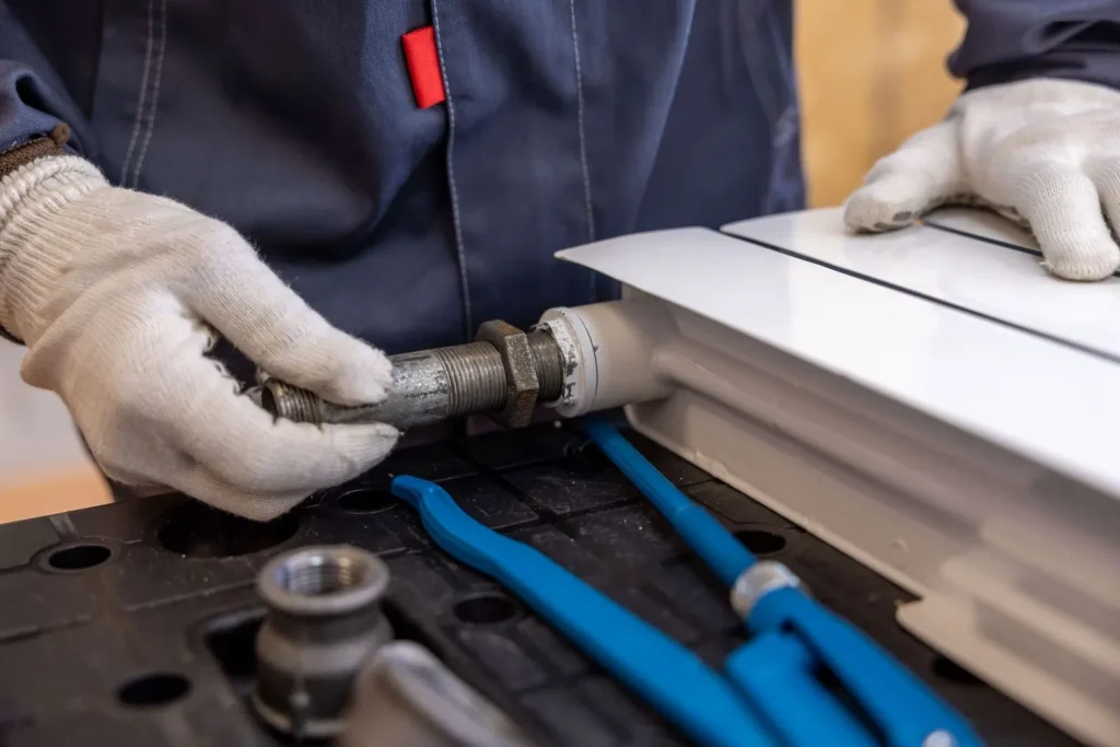 Plumber fitting a pipe with specialized tools