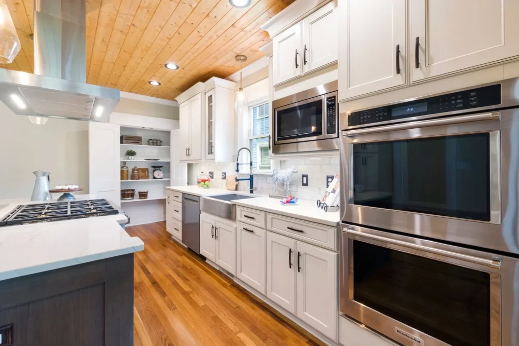 Remodeling marketing in Texas: remodeled kitchen with white cabinets and wood floors