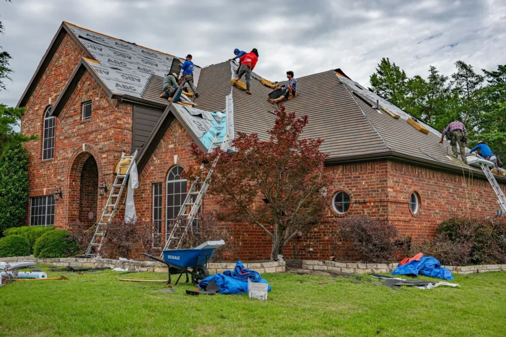 Roofing marketing in Texas: roofers replacing shingles on a brick home in Allen