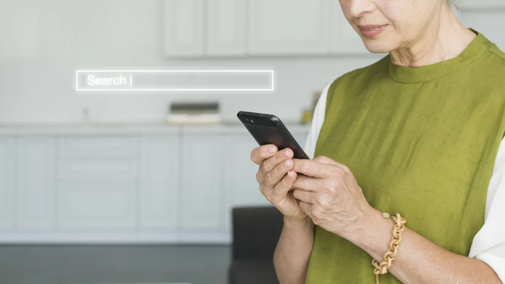 Woman searching for a trusted contractor on her phone in the kitchen